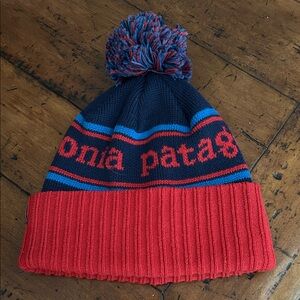 Patagonia Navy and Red Pom-Pom Beanie